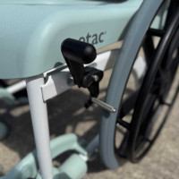 Etac Clean Self Propelled Shower Commode Chair in bathroom with lady