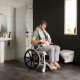 Etac Clean Self Propelled Shower Commode Chair in bathroom with man 