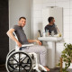 Etac Clean Self Propelled Shower Commode Chair in bathroom with man in mirror