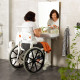 Etac Clean Self Propelled Shower Commode Chair in bathroom with lady in mirror