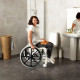Etac Clean Self Propelled Shower Commode Chair in bathroom with lady