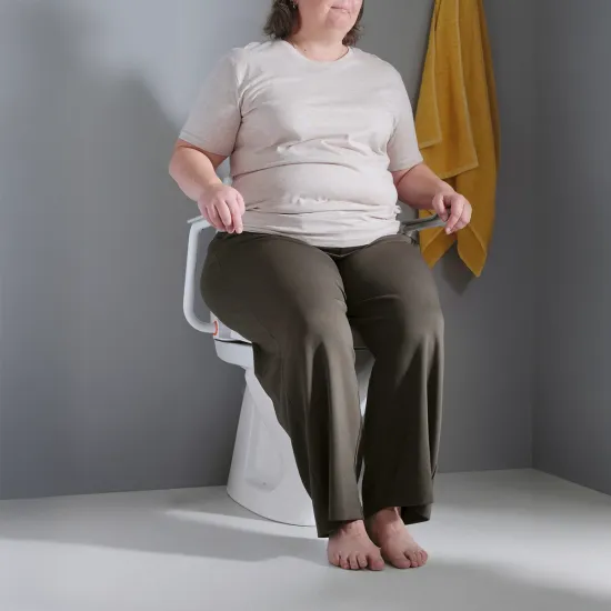 Etac Hi-Loo Toilet Seat with Arm's with person