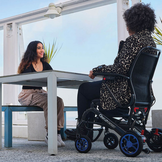 Quickie Q50R Carbon Folding Powered Wheelchair meeting friends