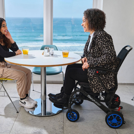 Quickie Q50R Carbon Folding Powered Wheelchair laughing with friends