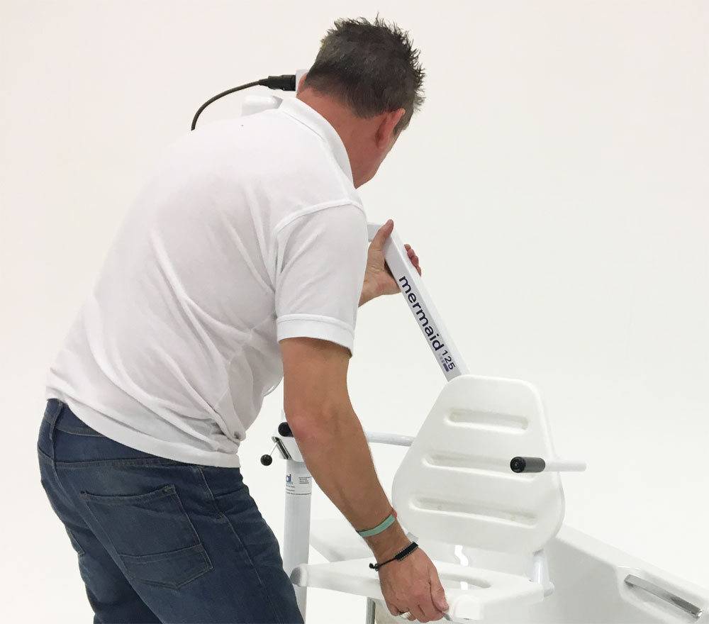Competent engineer testing a bath lift as part of a LOLER thorough examination